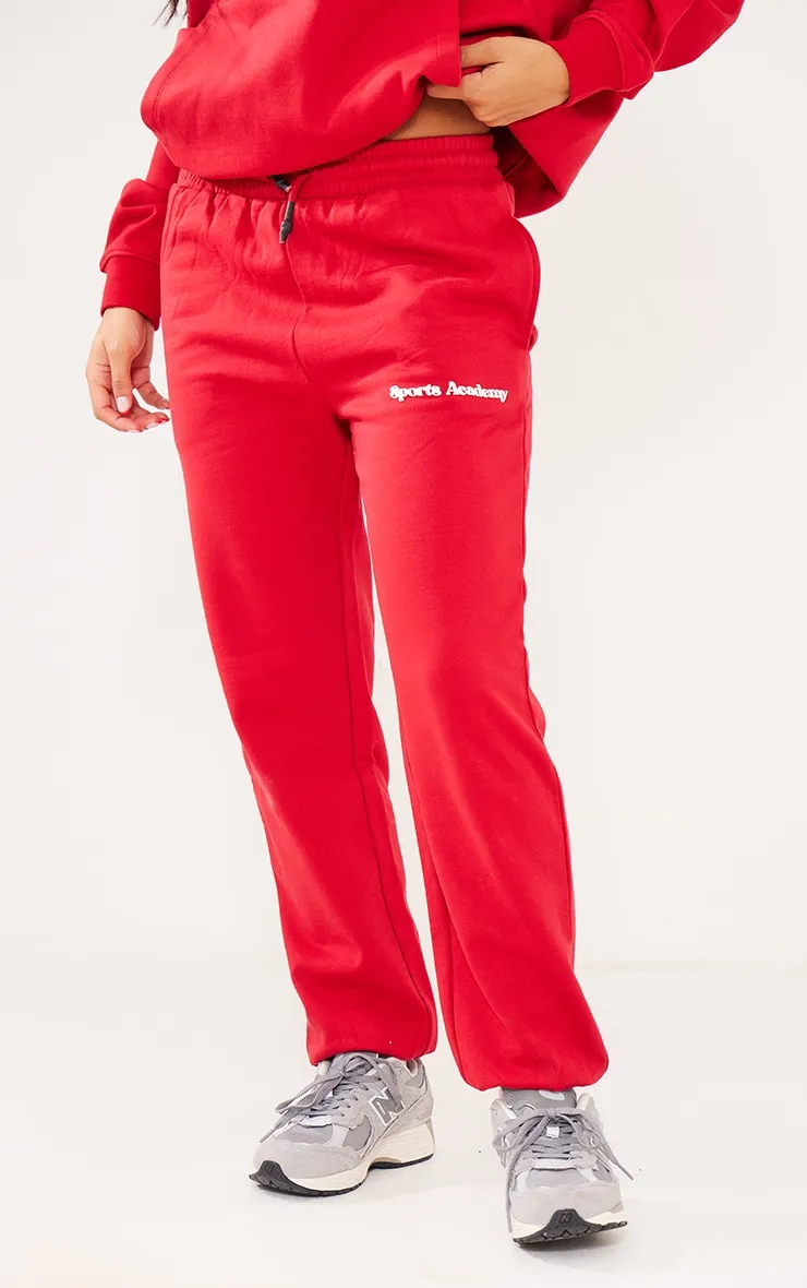 Jogging oversize rouge deluxe à imprimé Sports Academy